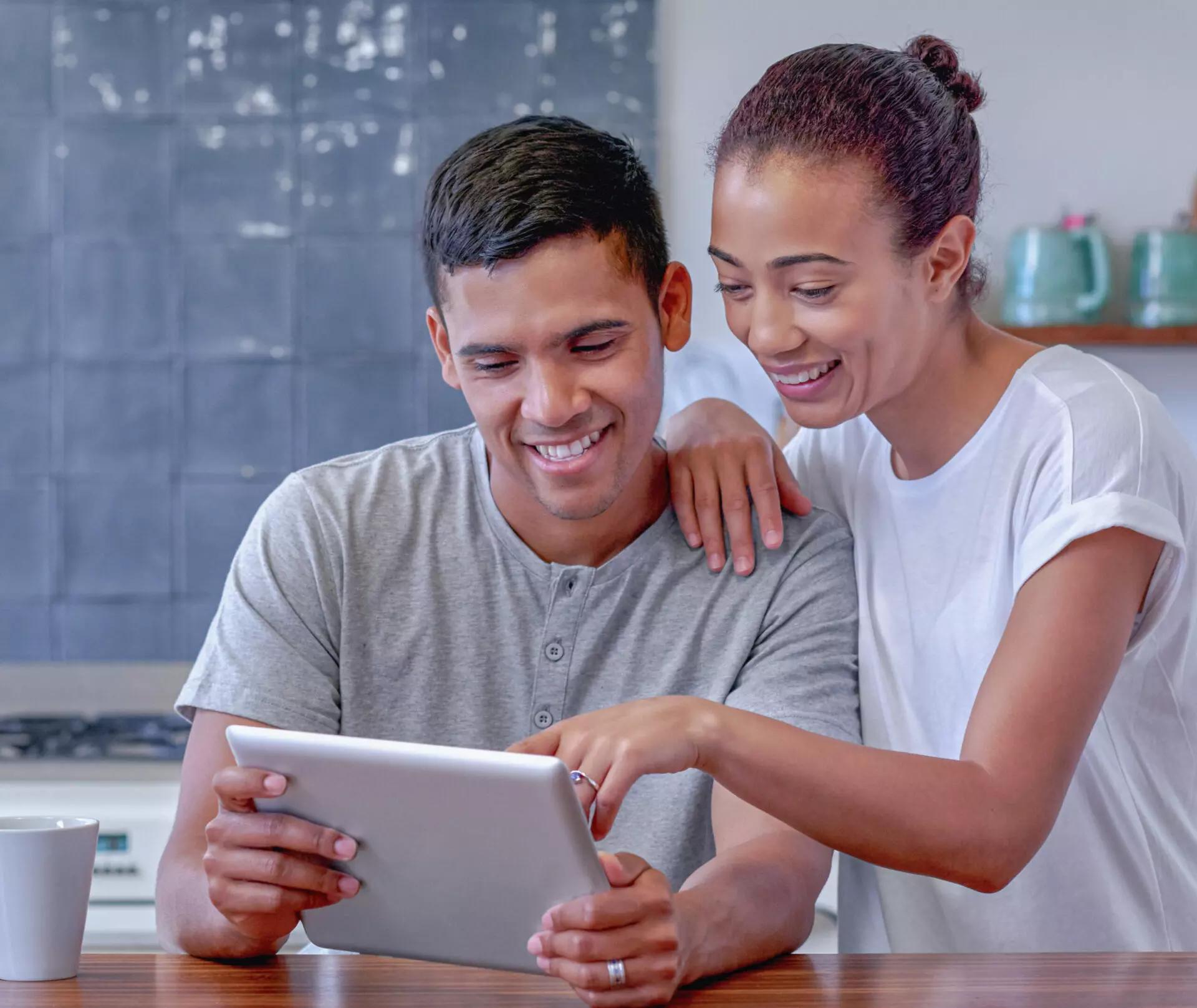 couple on ipad donating cryptocurrency