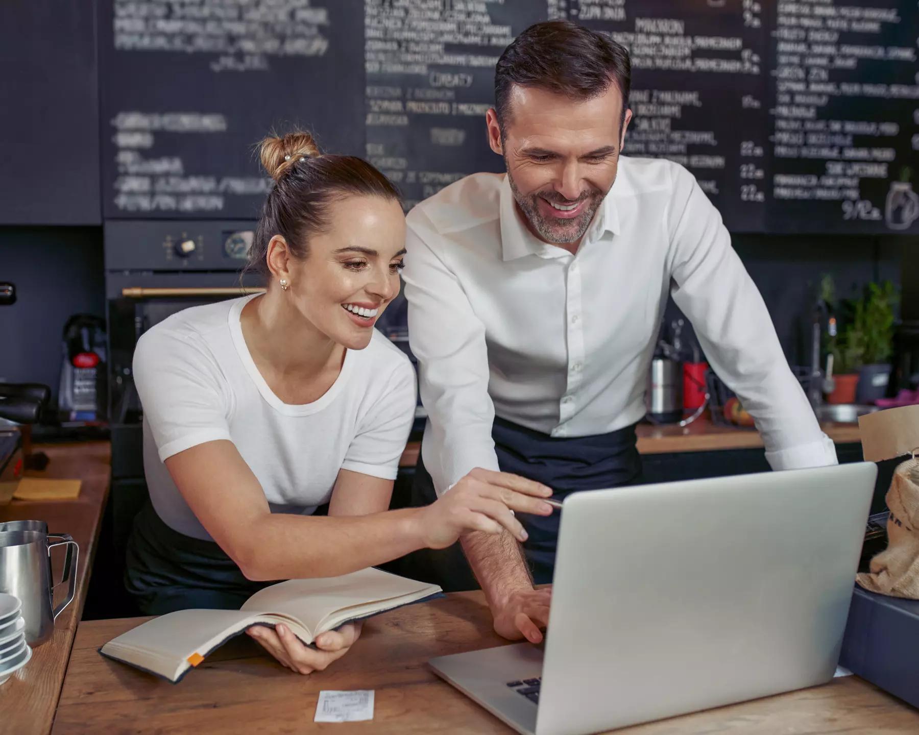 Two employees looking at computer discussing resources for their nonprofit